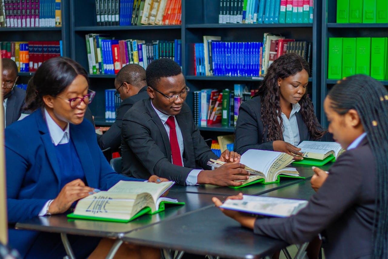 Focused group of adults studying in a library, fostering education and collaboration.